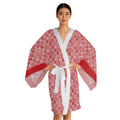 Woman wearing a red and white patterned robe on a white background