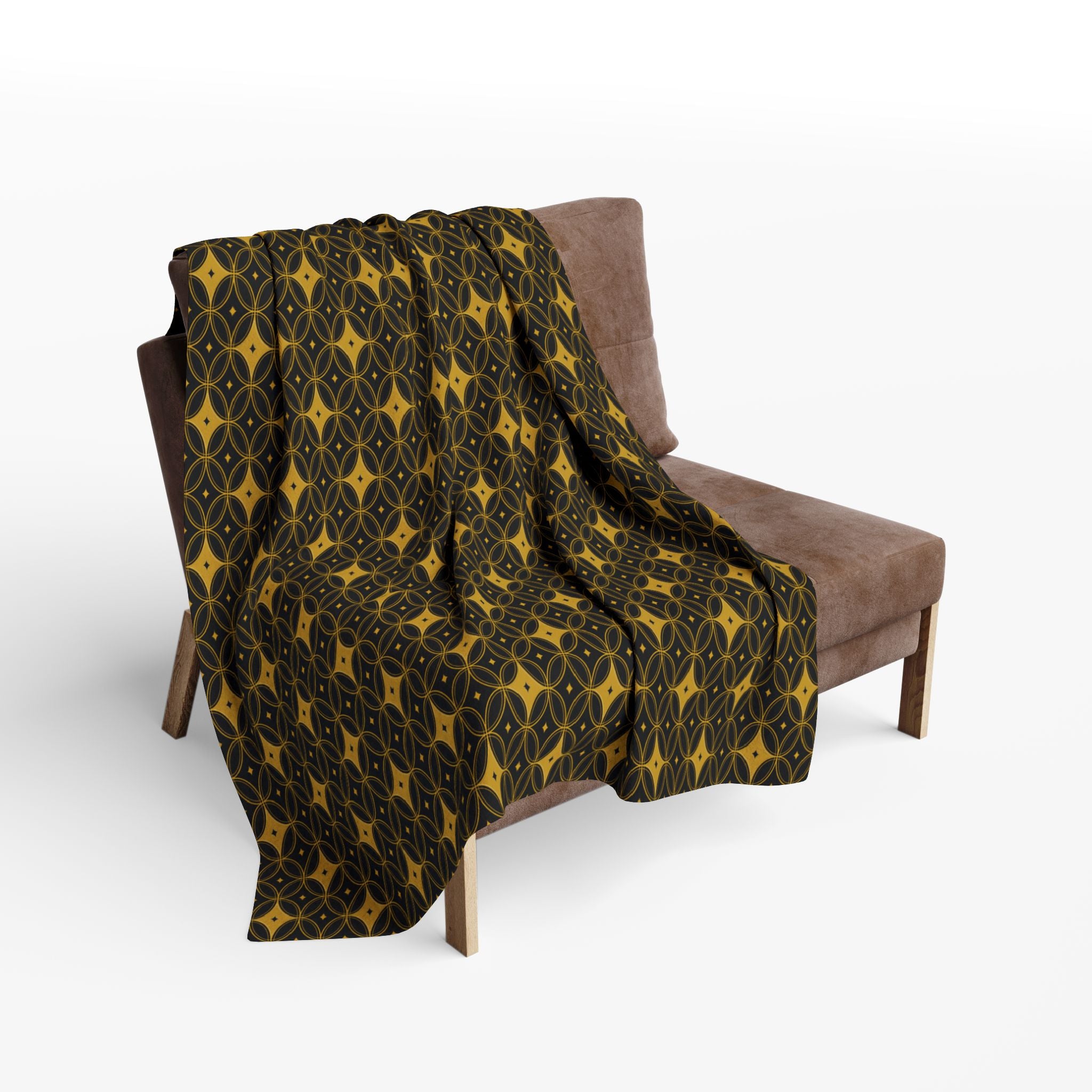Patterned blanket draped over a brown chair on a white background
