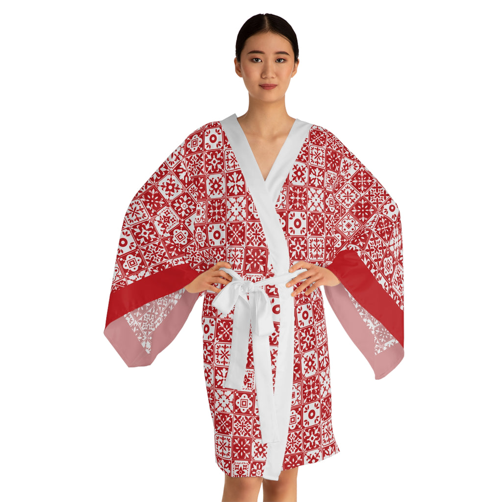 Woman wearing a red and white patterned robe on a white background