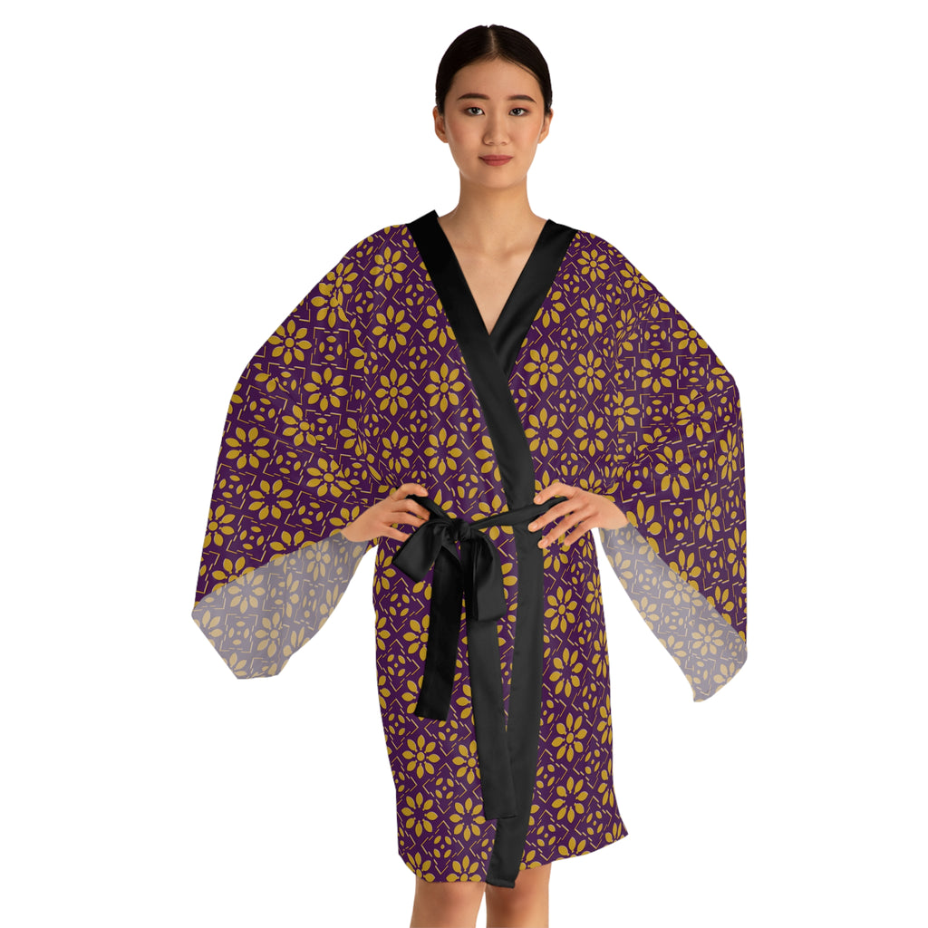 Woman wearing a purple and yellow patterned robe with a black belt on a white background