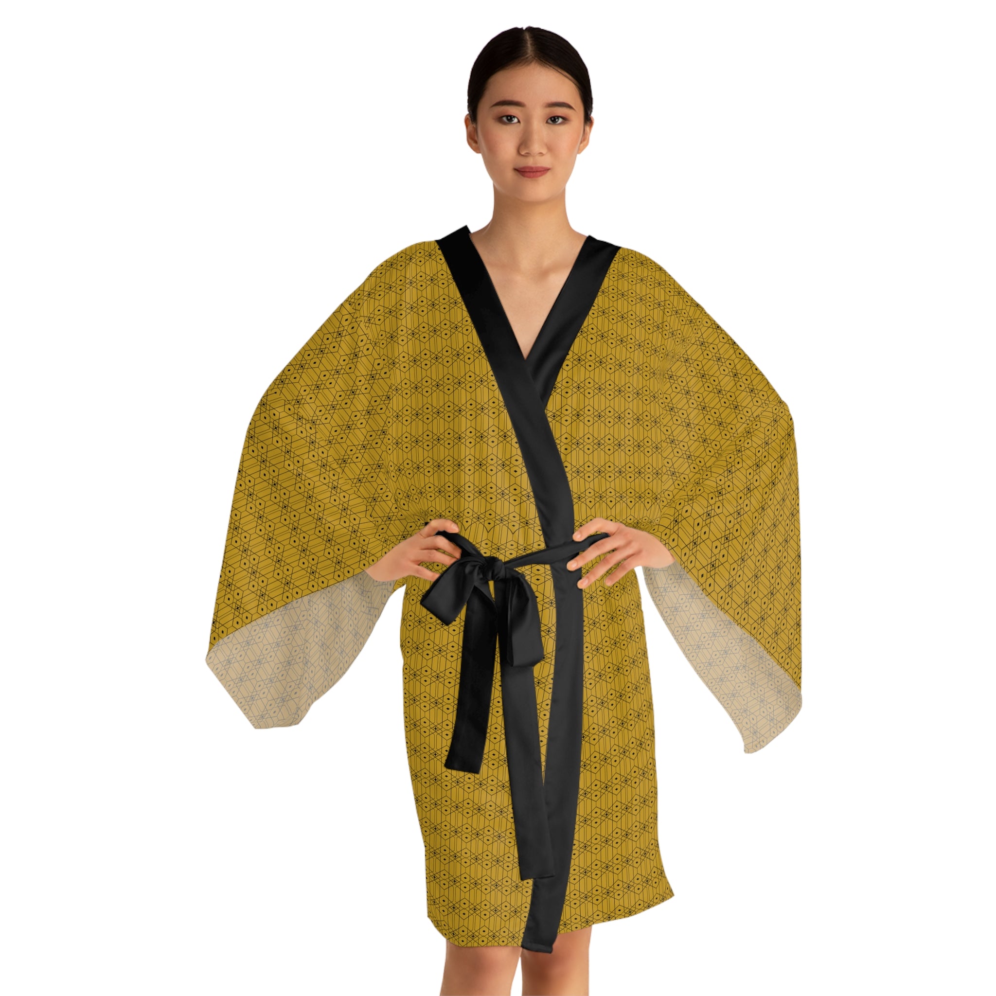 Woman wearing a yellow patterned robe with a black belt on a white background