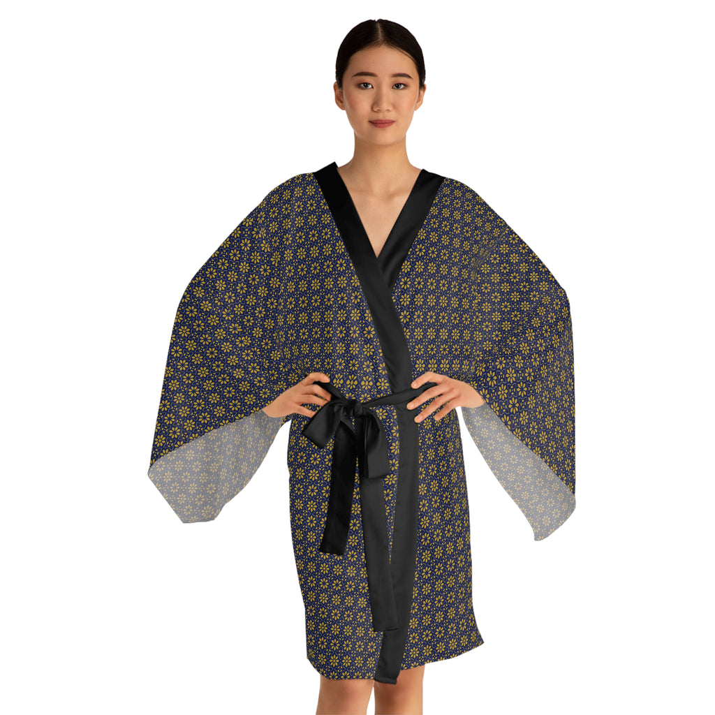Woman wearing a patterned robe with a black belt on a white background