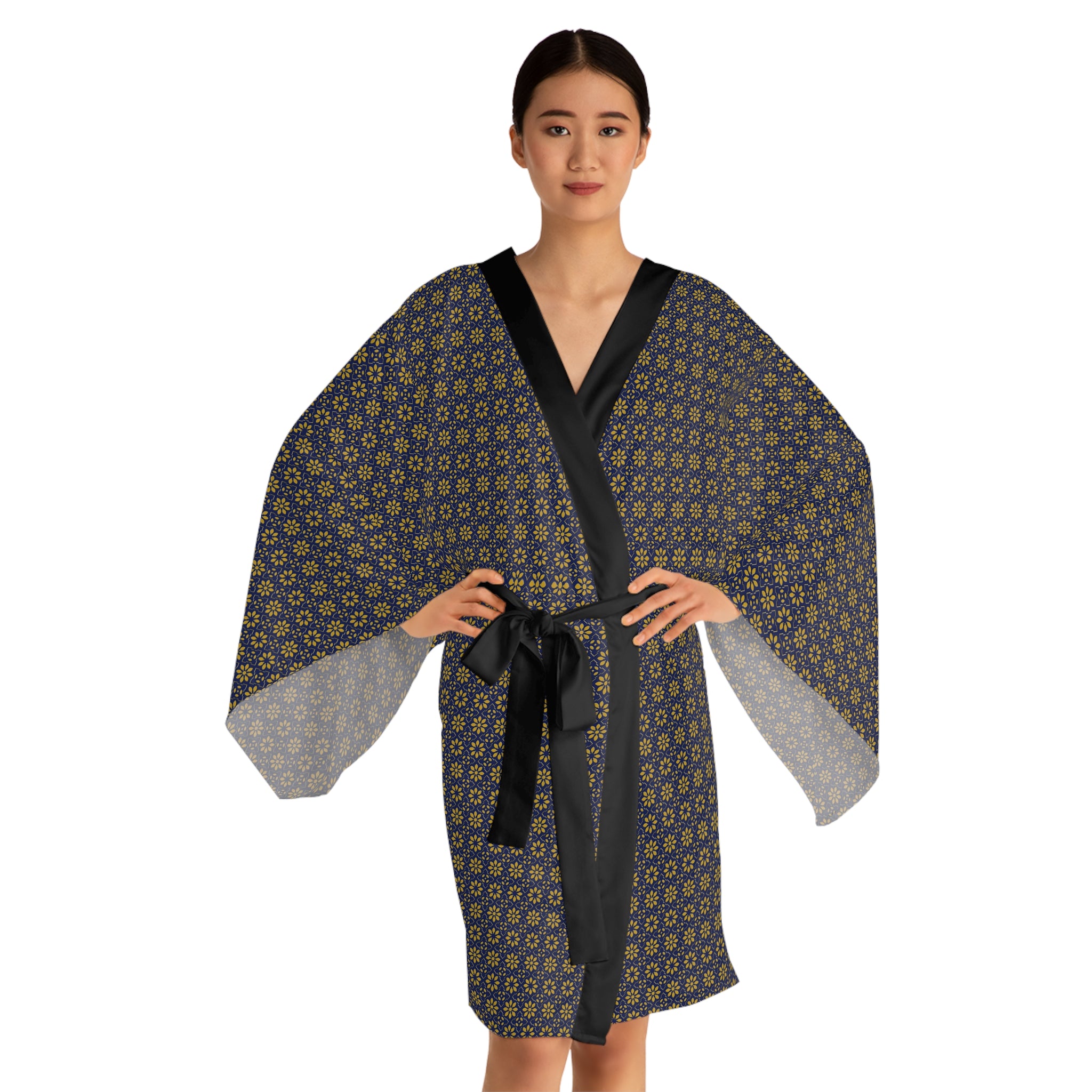Woman wearing a patterned robe with a black belt on a white background