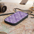 Purple patterned travel wallet on a map with a camera and phone in the background