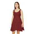 Woman wearing a red patterned dress on a white background