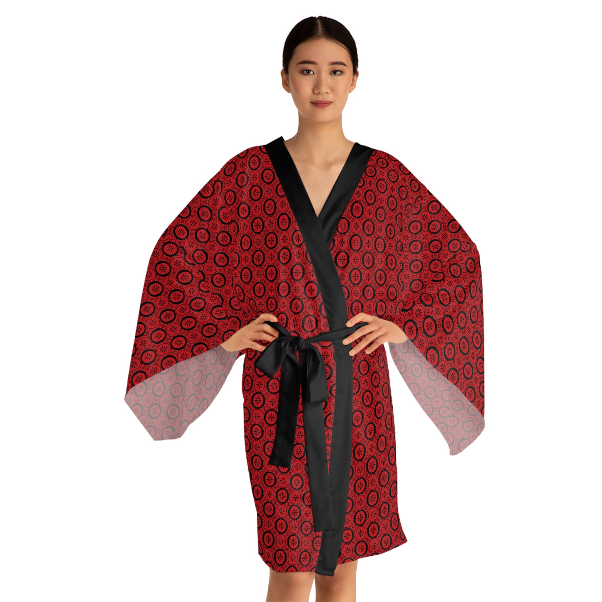 Woman wearing a red patterned robe with a black belt on a white background