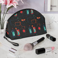 Makeup bag with colorful pattern on a marble surface with makeup items and flowers.